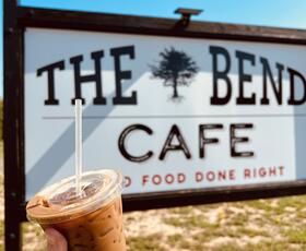 An iced coffee drink with a sign behind it