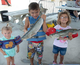 Kids showing off their catch at the International Grand Isle Tarpon Rodeo