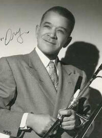 A signed portrait of Kid Ory holding a trombone
