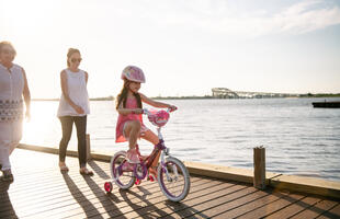 A child bikes across the Prien Lake Park boardwalk in Lake Charles.
