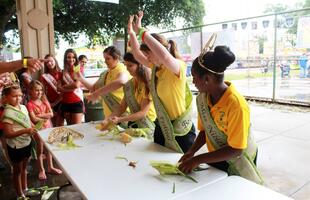 Students dressed as ears of corn participate in a corn-shucking contest.