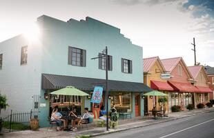 Colorful buildings line a Louisiana main street.