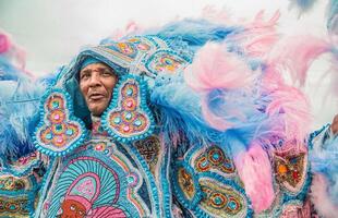 A Mardi Gras Indian wears a beautiful, elaborate blue costume at Jazz Fest.
