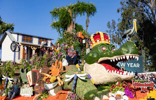 The 2025 Explore Louisiana Rose Parade float featured an alligator adorned with beads, carrying a Cajun dance hall, performers and pots of boiled seafood.