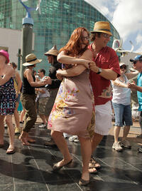French Quarter FestCouples dancing joyfully to live music at the French Quarter Festival in New Orleans, Louisiana.